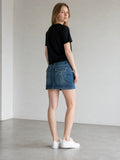 New York & Company blue denim Y2K mini skirt with embroidered back pockets and contrast stitching.