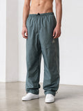 Rewearz vintage grey Adidas parachute cargo pants with reflective side stripes and drawstring ankles.