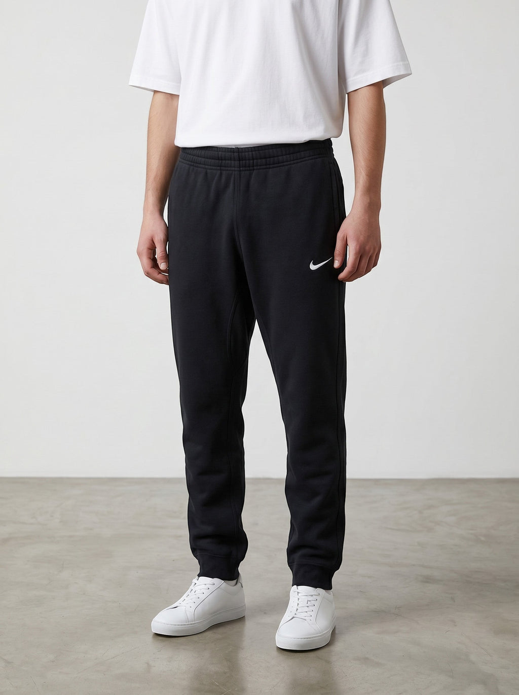 Rewearz black Nike jogging pants with embroidered solo swoosh logo, size small, classic straight fit.