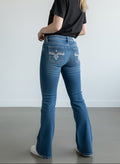 Rewearz blue denim bootcut jeans with embellished back pockets featuring fleur-de-lis embroidery and rhinestones.