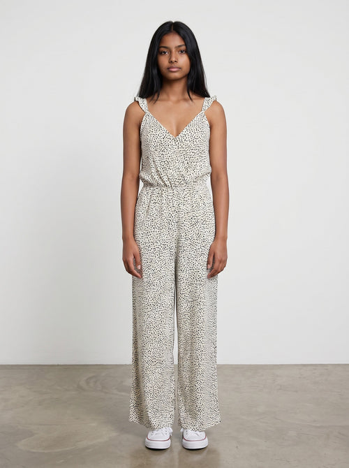 Rewearz cream and black polka dot wide leg jumpsuit with ruffle straps and V-neck