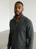 Rewearz dark grey Tommy Hilfiger half-zip sweater with embroidered logo and striped collar detail.
