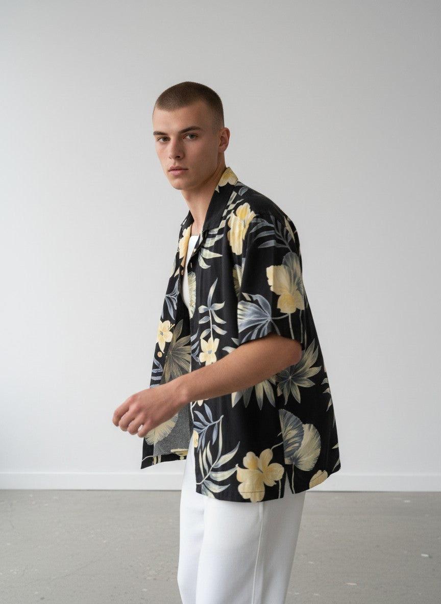 Rewearz black 100% silk Hawaiian shirt with yellow flowers and tropical leaves pattern. Relaxed fit, short sleeves.