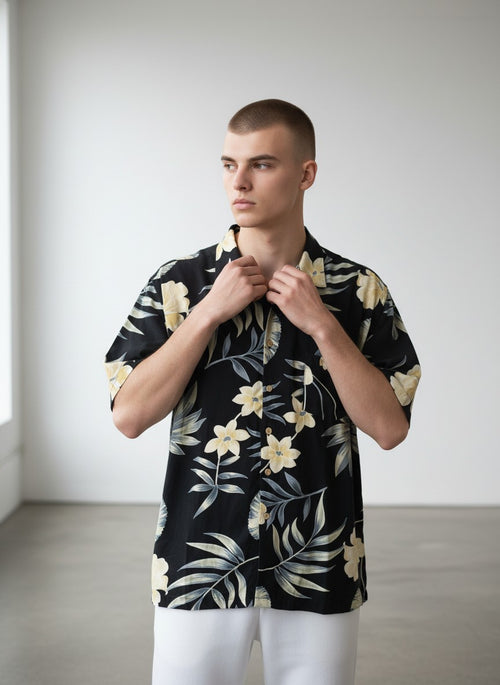 Rewearz black 100% silk Hawaiian shirt with yellow flowers and tropical leaves pattern, short sleeves, relaxed fit.