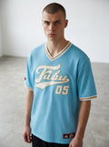 Rewearz light blue FUBU oversized baseball jersey with white and gold trim and embroidered FUBU logo and '05'.
