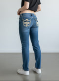 RewearzHere blue denim jeans with straight fit, embroidered pockets with rhinestones, and grunge Y2K style.