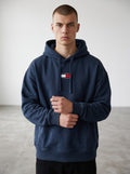 Tommy Jeans navy blue cotton boxy fit hoodie with embroidered central logo and drawstrings.